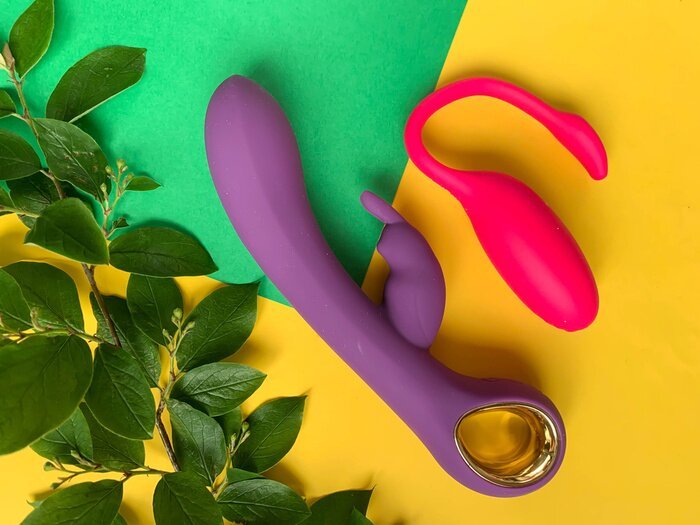 sex-toys-two-vibrators-on-a-yellow-background-useful-for-adult-sex-shop